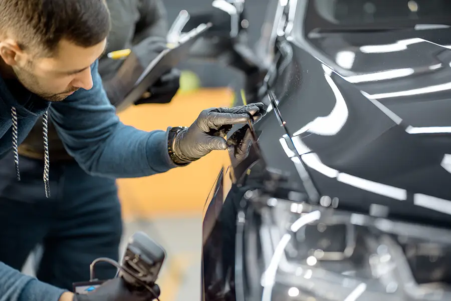 Car inside a state-of-the-art paint booth during the refinishing process.