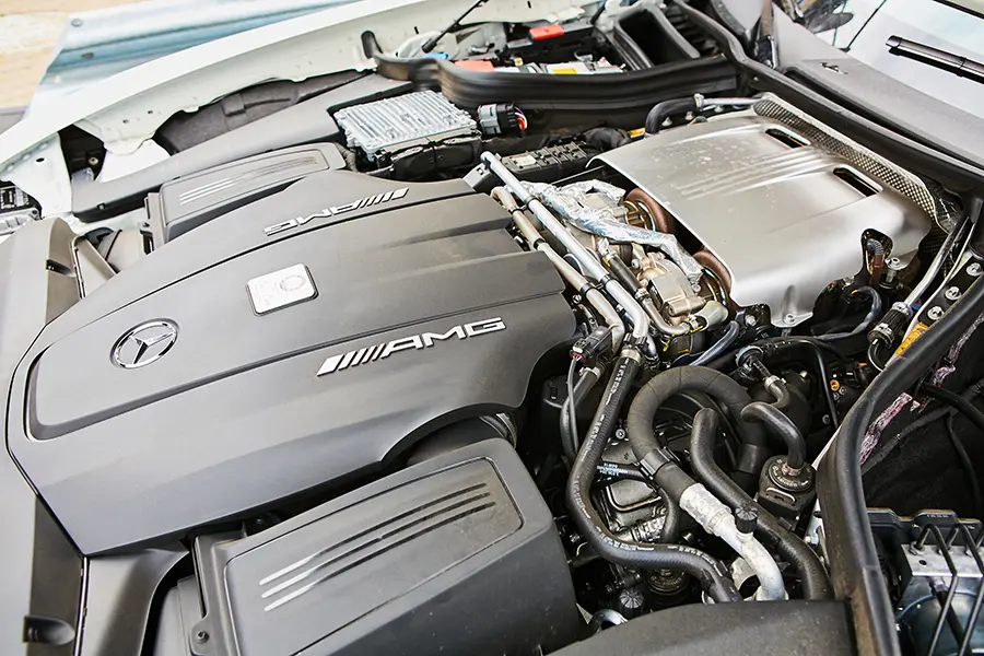 Technician working on the engine of a car.